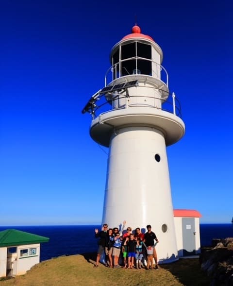 A close up image of Double Island Point Lighthouse with a blue sky in the background